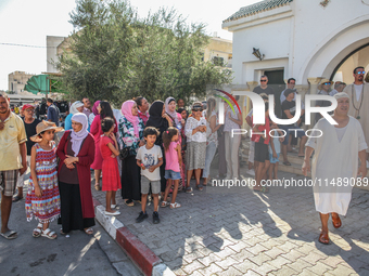 Women, devotees of a Sufi order, and local residents are waiting for the start of the annual procession of Sidi Bou Said outside the mausole...