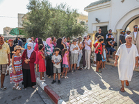 Women, devotees of a Sufi order, and local residents are waiting for the start of the annual procession of Sidi Bou Said outside the mausole...