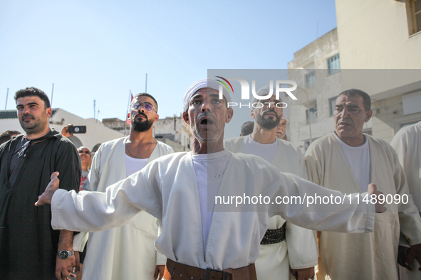 Devotees from a Sufi order are dancing and chanting spiritual songs during the annual procession of Sidi Bou Said in Ariana, Tunisia, on Aug...