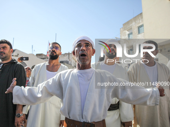 Devotees from a Sufi order are dancing and chanting spiritual songs during the annual procession of Sidi Bou Said in Ariana, Tunisia, on Aug...