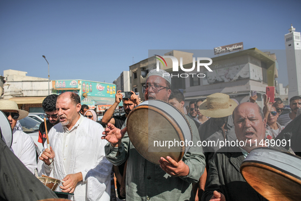 Devotees from a Sufi order are dancing and chanting spiritual songs during the annual procession of Sidi Bou Said in Ariana, Tunisia, on Aug...