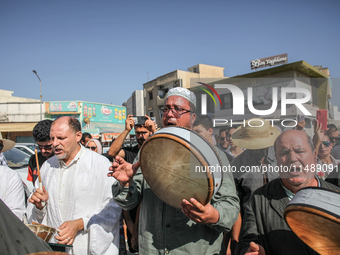 Devotees from a Sufi order are dancing and chanting spiritual songs during the annual procession of Sidi Bou Said in Ariana, Tunisia, on Aug...