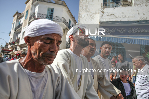 Devotees from a Sufi order are dancing and chanting spiritual songs during the annual procession of Sidi Bou Said in Ariana, Tunisia, on Aug...