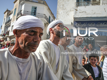 Devotees from a Sufi order are dancing and chanting spiritual songs during the annual procession of Sidi Bou Said in Ariana, Tunisia, on Aug...