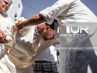 A devotee from a Sufi order is entering a state of trance during the annual procession of Sidi Bou Said in Ariana, Tunisia, on August 11, 20...