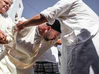 A devotee from a Sufi order is entering a state of trance during the annual procession of Sidi Bou Said in Ariana, Tunisia, on August 11, 20...