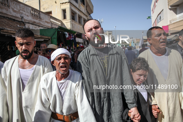 Devotees from a Sufi order are dancing and chanting spiritual songs during the annual procession of Sidi Bou Said in Ariana, Tunisia, on Aug...