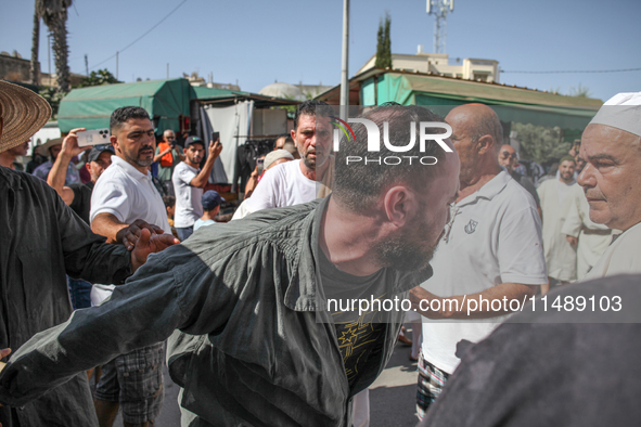 A devotee from a Sufi order is entering a state of trance during the annual procession of Sidi Bou Said in Ariana, Tunisia, on August 11, 20...