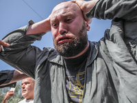 A follower of a Sufi order is swallowing pieces of glass and has a bloody mouth while in a state of trance during the annual procession of S...