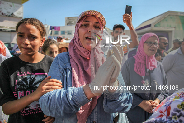 Women are chanting spiritual songs as they are attending the procession of Sidi Bou Said in Ariana, Tunisia, on August 11, 2024. The annual...