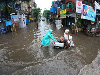 Vehicles are driving through a flooded street during the heavy monsoon rain in Kolkata, India, on August 18, 2024. (