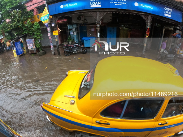 Vehicles are driving through a flooded street during the heavy monsoon rain in Kolkata, India, on August 18, 2024. 