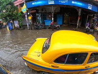 Vehicles are driving through a flooded street during the heavy monsoon rain in Kolkata, India, on August 18, 2024. (