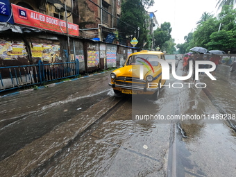 Vehicles are driving through a flooded street during the heavy monsoon rain in Kolkata, India, on August 18, 2024. (