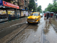 Vehicles are driving through a flooded street during the heavy monsoon rain in Kolkata, India, on August 18, 2024. (