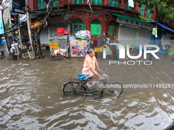 A street is flooding during the heavy monsoon rain in Kolkata, India, on August 18, 2024. (