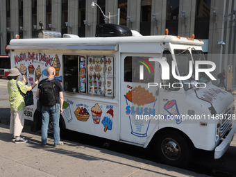 People are purchasing ice cream from an ice cream truck at Nathan Philips Square in downtown Toronto, Ontario, Canada, on August 14, 2024. (