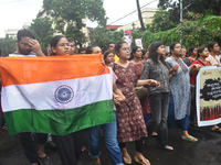 Junior doctors are holding India's national flag and marching on the street during a protest condemning the rape and murder of a trainee med...