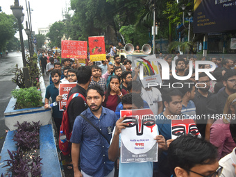 Doctors are holding posters and marching on the street during a protest condemning the rape and murder of a trainee medic at a government-ru...