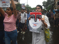 Junior doctors are holding posters and marching on the street during a protest condemning the rape and murder of a trainee medic at a govern...