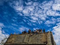 People are looking towards the river Jhelum along with a cloudy sky in Sopore, Jammu and Kashmir, India, on August 18, 2024 (