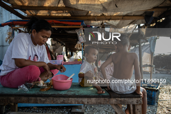 A small shop is operating in a slum settlement in Jakarta, Indonesia, on August 18, 2024. 