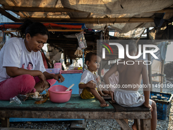 A small shop is operating in a slum settlement in Jakarta, Indonesia, on August 18, 2024. (