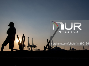 A man is walking near the port area in Jakarta, Indonesia, on August 18, 2024. (