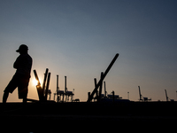 A man is walking near the port area in Jakarta, Indonesia, on August 18, 2024. (