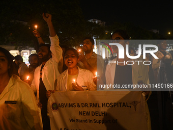 Medical professionals and students are shouting slogans and holding lit candles in a protest demanding justice following the rape and murder...