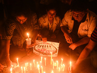 Medical professionals and students are holding placards and lighting candles in a protest demanding justice following the rape and murder of...