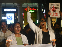 Medical professionals and students are shouting slogans in a protest demanding justice following the rape and murder of a trainee medic at a...