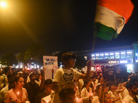 A girl is waving the Indian National Flag in a protest march by medical professionals and students demanding justice following the rape and...