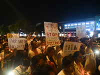 Medical professionals and students are holding placards and shouting slogans in a protest march demanding justice following the rape and mur...