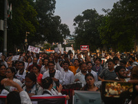 Medical professionals and students are holding placards and shouting slogans in a protest march demanding justice following the rape and mur...