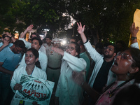 Medical professionals and students are shouting slogans in a protest march demanding justice following the rape and murder of a trainee medi...