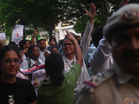 Medical professionals and students are shouting slogans in a protest march demanding justice following the rape and murder of a trainee medi...