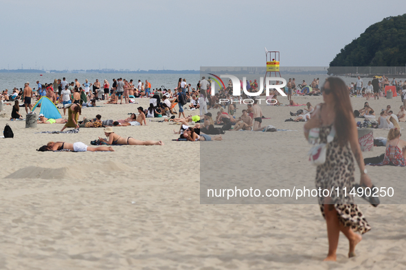 People are seen at the beach in Gdynia, Poland on August 18, 2024. 