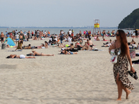 People are seen at the beach in Gdynia, Poland on August 18, 2024. (