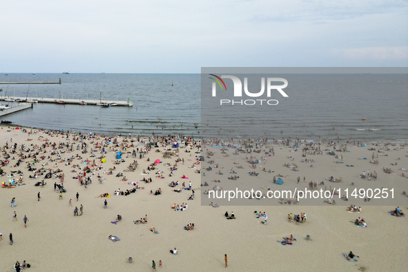 People are seen at the beach in Gdynia, Poland on August 18, 2024. 