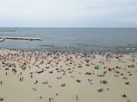 People are seen at the beach in Gdynia, Poland on August 18, 2024. (