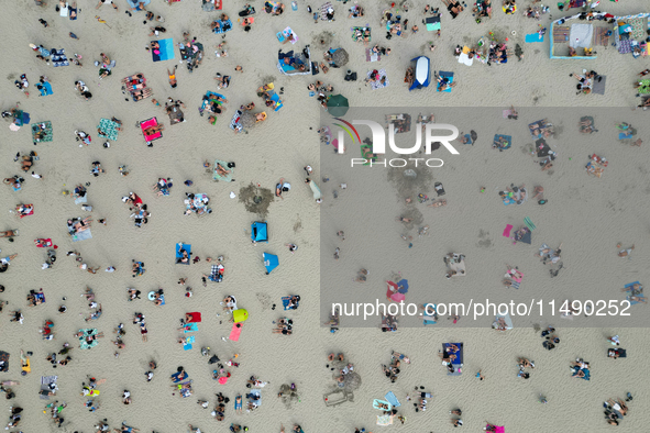 People are seen at the beach in Gdynia, Poland on August 18, 2024. 