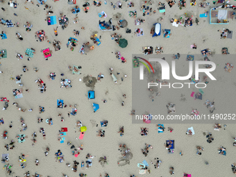 People are seen at the beach in Gdynia, Poland on August 18, 2024. (