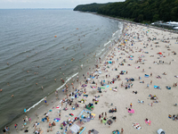 People are seen at the beach in Gdynia, Poland on August 18, 2024. (