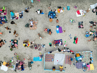 People are seen at the beach in Gdynia, Poland on August 18, 2024. (