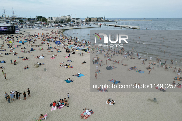 People are seen at the beach in Gdynia, Poland on August 18, 2024. 