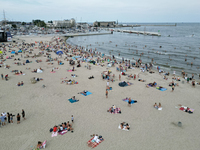 People are seen at the beach in Gdynia, Poland on August 18, 2024. (