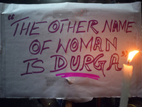 A woman is holding a placard and candle while protesting over the sexual assault and murder of a Kolkata woman doctor in Kolkata, India, on...