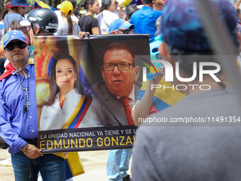 An activist is holding a banner with political phrases during a rally in downtown San Cristobal, Venezuela, on August 17, 2024. Citizens opp...