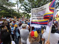 Several activists are holding banners and Venezuelan flags while gathering at a rally in Los Mangos square in San Cristobal, Venezuela, on A...